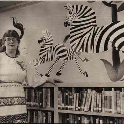 A photo view of Dahlov Ipcar with her mural.