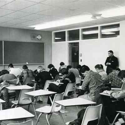 Class room with students sitting at desks. c. 1962