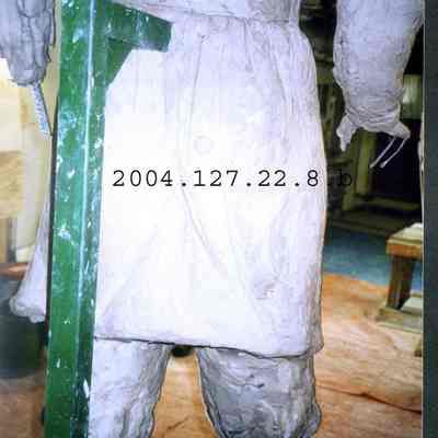 Color photograph of a back view of the lower half of the JLC statue.