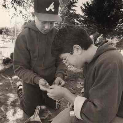 A photo view of 2 boys examining a recent find. 10/14/1992