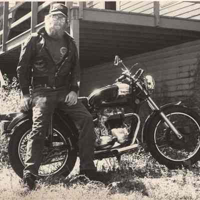 A photo view of a man and his motorcycle. 8/24/1992.