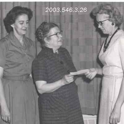 Women presenting check