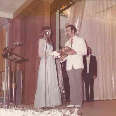 Mary Ann Lincameli giving Gene Gagne a gift from the contestant