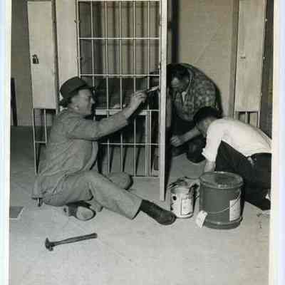 Three Men Painting a Jail Cell