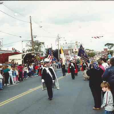 A color photograph of the spectator waiting for the 250th Anniversary Parade to arrive. A color photograph of the spectator waiting for the 250th Anniversary Parade to arrive. A color photograph of the spectator waiting for the 250th Parade.