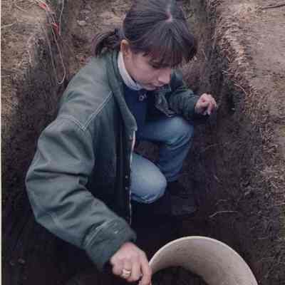 A photo view of a girl on an archeological dig. 11/19/1991.