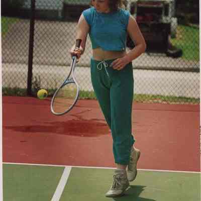 A photo view of a woman playing tennis. 6/11/1987.