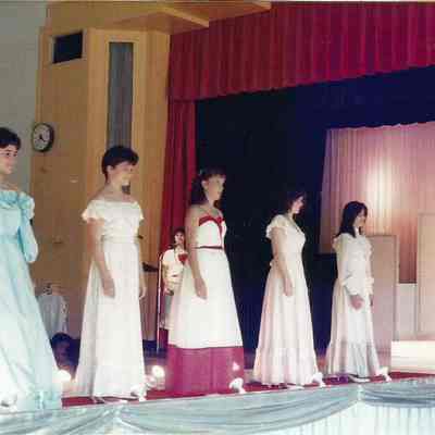 A color photograph of the contestants doing a series of quater turns.