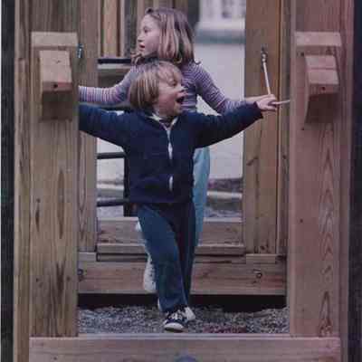 A photo view of two children playing. 4/22/1987