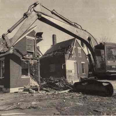A photo view of a house being demolished.