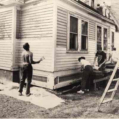 A photo view of volunteers working on a house. 9/21/1992.