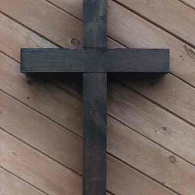 A photo view of a wooden cross on a wall. 8/4/1989.