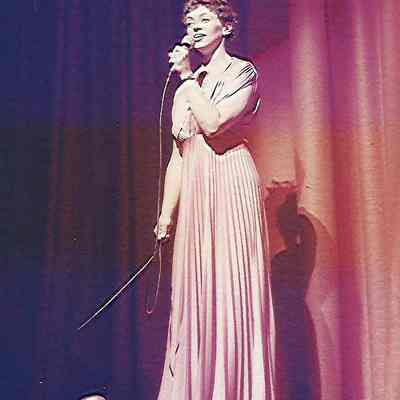 A color photograph of Sharon Hinckley singing
