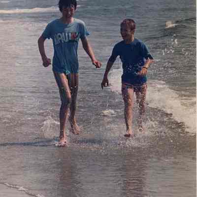 A photo view of two boys playing in the ocean. 6/20/1988.