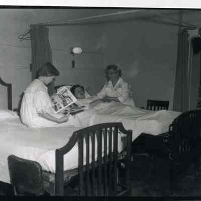 Females in Brunswick hospital room attended by a nurse