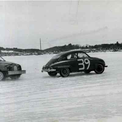 A photo of 2 cars racing on the New Meadows River.