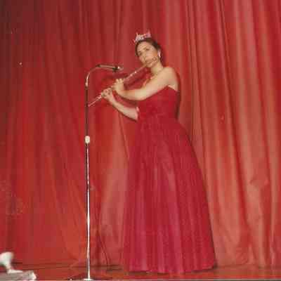 A color photograph of Miss Brunswick Kristi Kaknes who is playing the flute