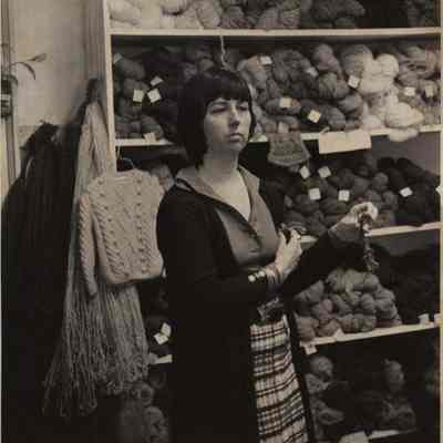 A photo view of a lady in a yarn shop. 7/9/1976.
