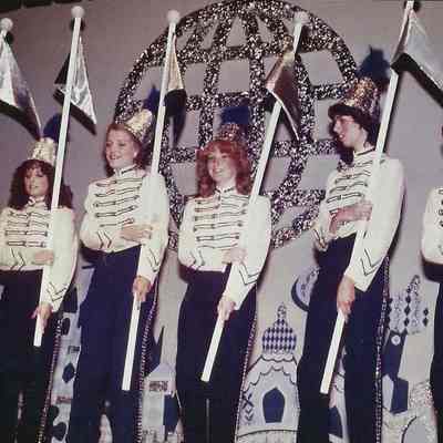 A color photograph of the group doing the opening number.