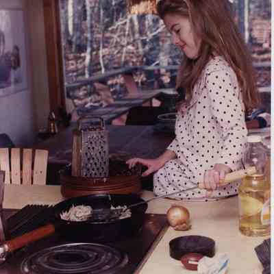 A photo view of a girl cooking. 12/10/1990.