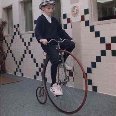 A photo view of a boy on an antique bicycle. 11/26/1991.