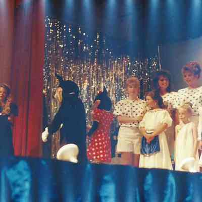 Mickey and Mini Mouse leaving the stage.