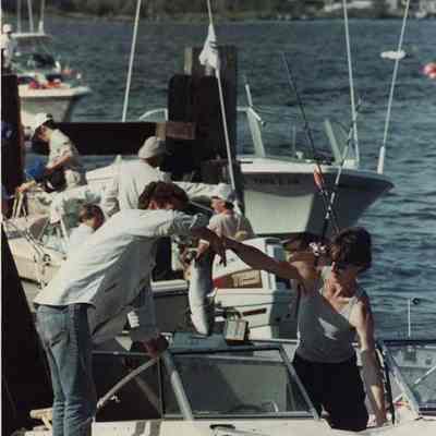 A photo view of people with a fish. 8/12/1989.