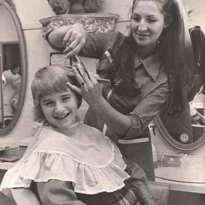 Woman Cutting a Girl's Hair