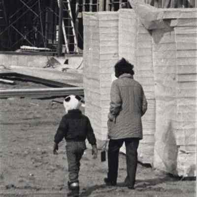 Two People Walking at a Construction Site