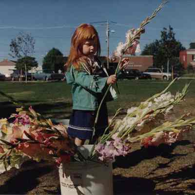 A photo view of a girl and some flowers. 9/14/1989.