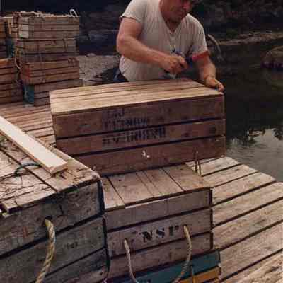 A photo view of a man building boxes. 7/21/1988