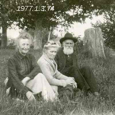 Three People Sitting Outdoors