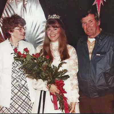 A color photograph of 1984-85 Brunswick Teen Queen Kelley Donovan with her parents