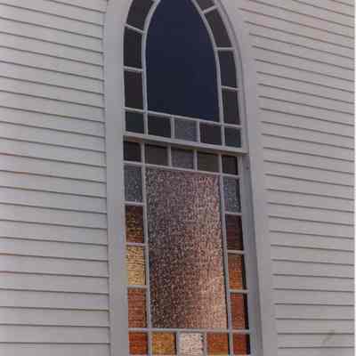 A photo view of a stained glass window. 9/22/1989.