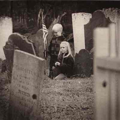A photo view of two children in a cemetery. 1/21/1975.