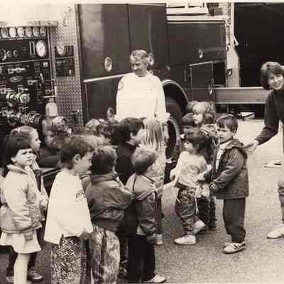 A photo view of children visiting a fire station. 5/15/1992.