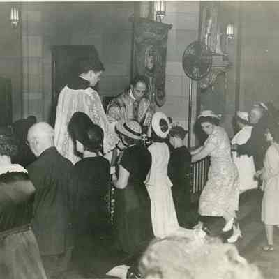Father Dauphin giving Communion