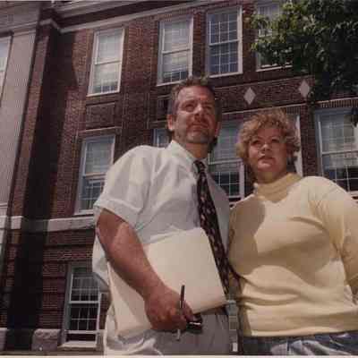 A photo view of two people in front of the Hawthorne School. 6/4/1992.
