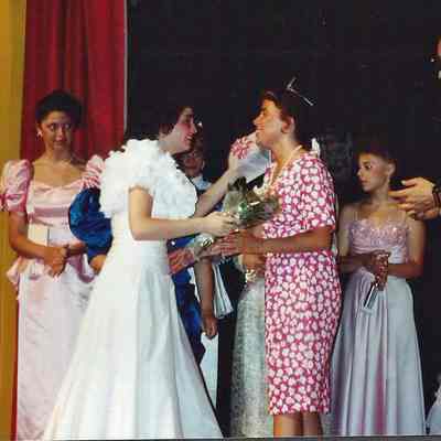 Chressie Gagne presenting flowers to M.C. Wendy Mercier