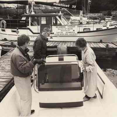 A photo view of Robert Small with customers. 4/27/1992.