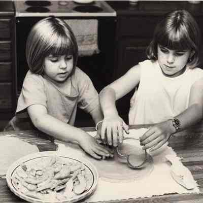 A photo view of two children making cookies. 9/25/1992.