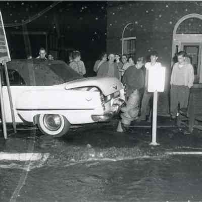 A photo of a car that hit a fire hydrant. 6/24/1955.