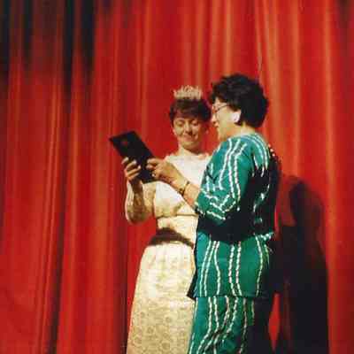 Sharon Costedio showing the plaque to Mrs. Marion Crooker.