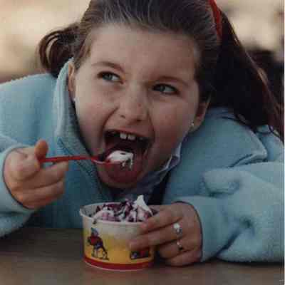 A photo view of a child eating ice cream. 4/26/1989.