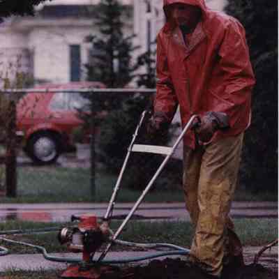 A photo view of a man tilling his garden. 5/15/1989.