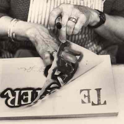 A photo view of a woman making a sign. 10/30/1992.