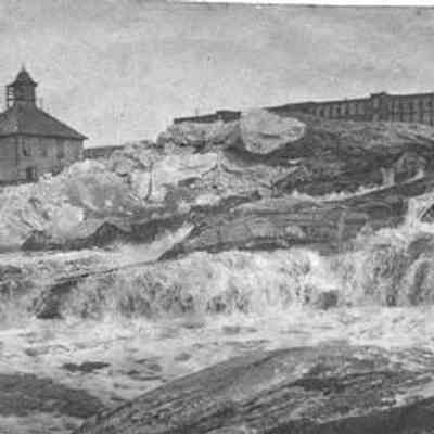 A photo of the Falls with Cabot Mill in the background.