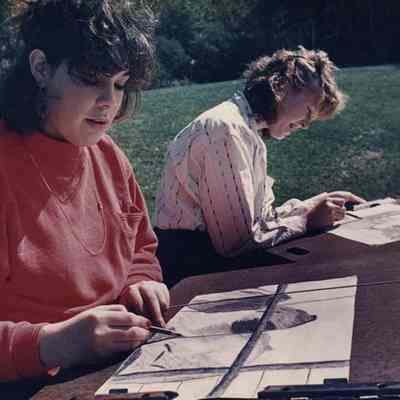 A photo view of two girls working on drawings. 9/28/1988.