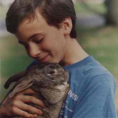 A photo view of a boy and his pet rabbit. 5/9/1988.