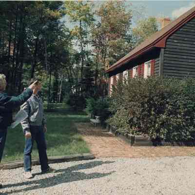A photo view of two men looking at a house. 10/1/1991.